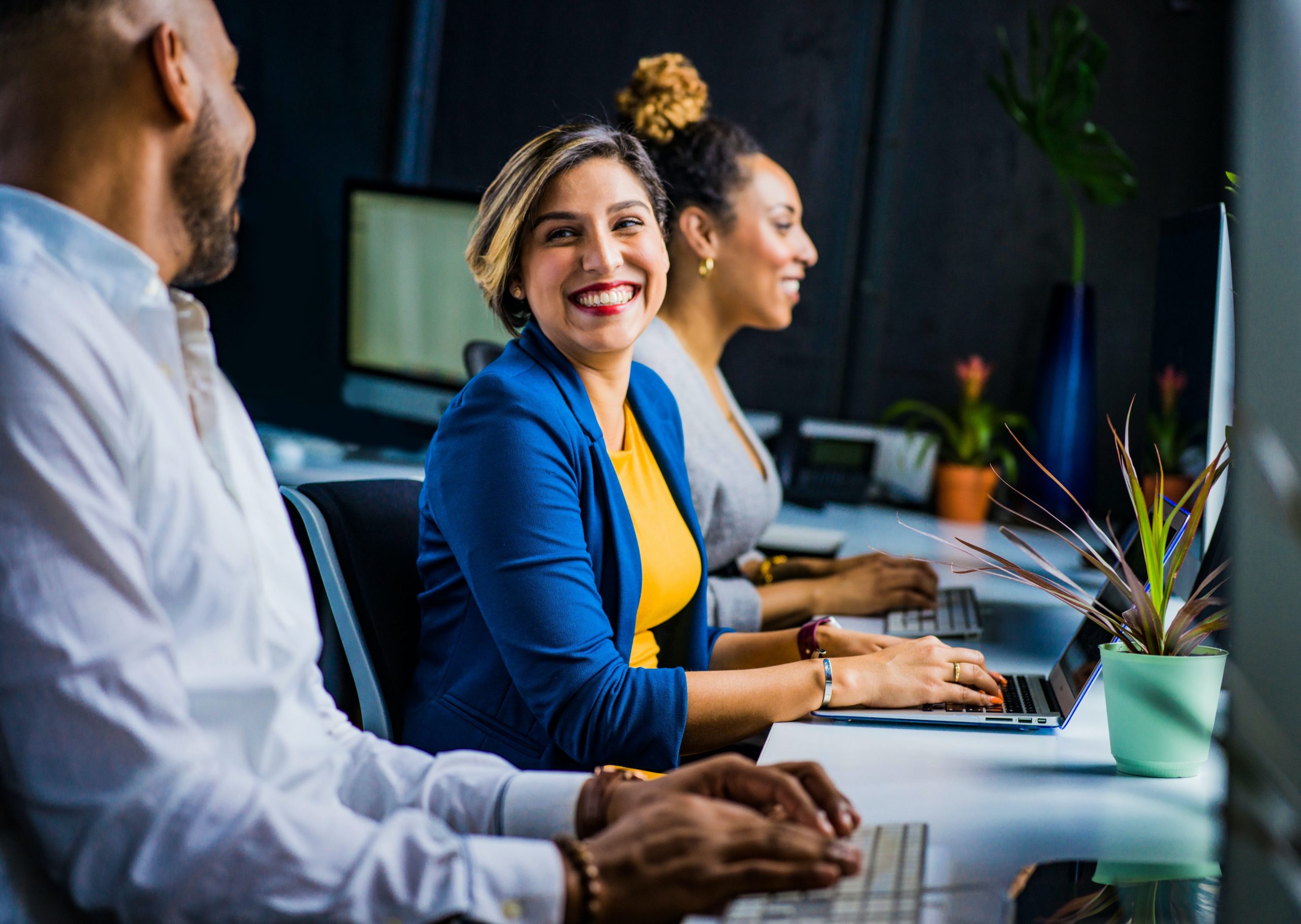 happy employees at their laptops