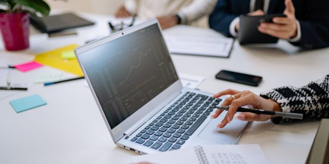 person typing on their laptop